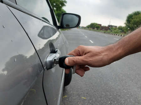 Picture of a person unlocking his car with keyの写真素材