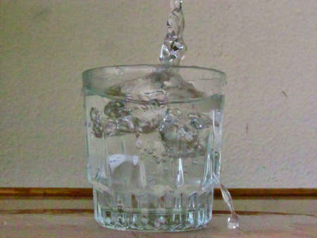 Splash of water coming out of glass of water