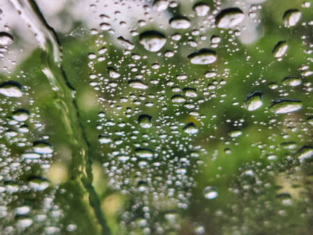 Picture of water droplets on glass shot on rainy day