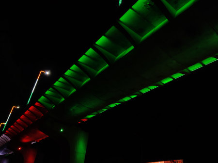 Image of a flyover illuminated in saffron, white and greenの写真素材