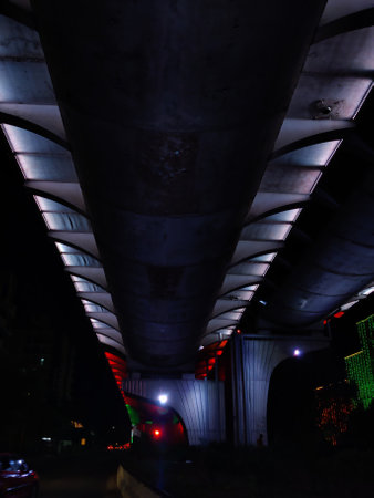 Image of a flyover illuminated in saffron, white and greenの写真素材