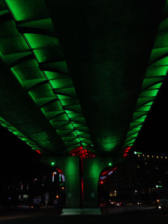 Image of a flyover illuminated in saffron, white and greenの写真素材