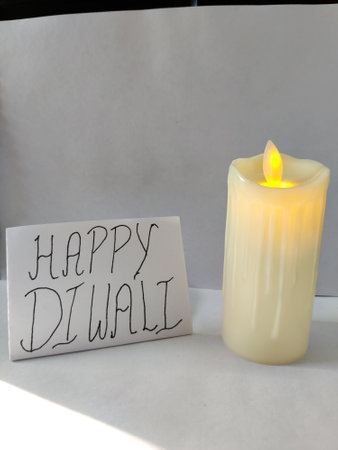 Picture of lit candle. Diwali Celebration. A placard with Happy Diwali written on itの写真素材