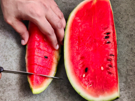 Picture of red slices of watermelon fruit cut shot during daylight in summers. Watermelon is rich in vitamins.の写真素材