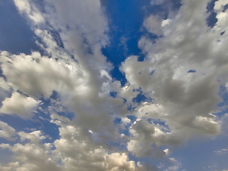 Picture of white clouds shot against blue sky on a cloudy day in summers. Rain in summers.の写真素材