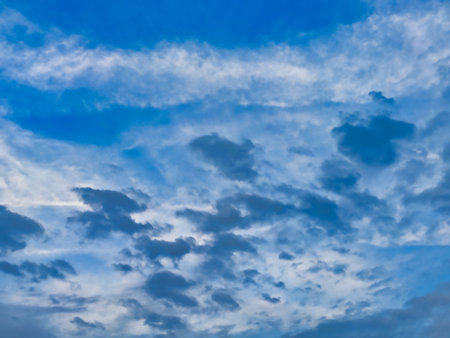 Picture of white clouds in blue sky shot during daylight on a cloudy day.の写真素材