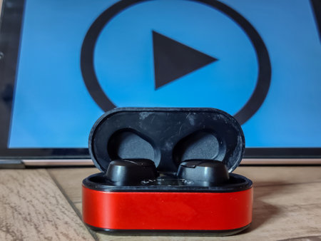 Headphones with play button on the background of a computer monitor.の写真素材