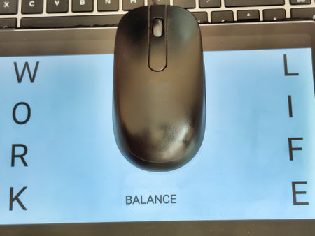 Picture of a computer mouse on a laptop with the words WORK, LIFE and BALANCE written on a screen