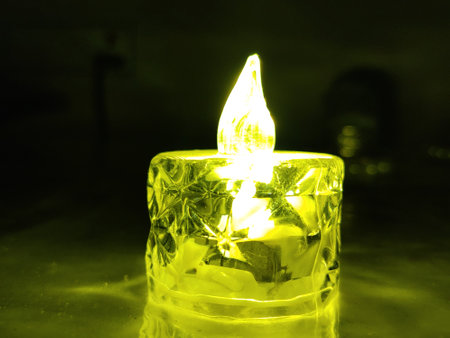 Candle light in a dark room, closeup of photo.の写真素材