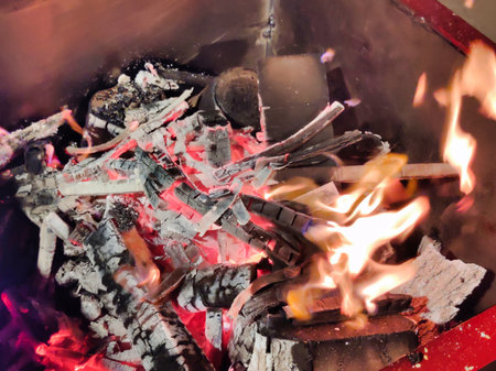 Burning firewood in the fireplace, close-up of photo