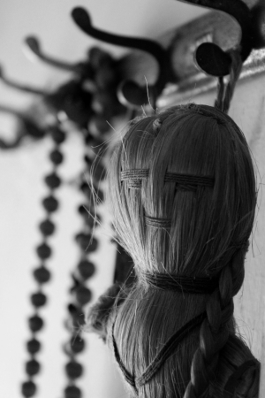 A doll made of hey threads and a necklace made of  wooden beads used by old age person to chant the name of god  Symbolizes belonging and togetherness among the two generationsの写真素材