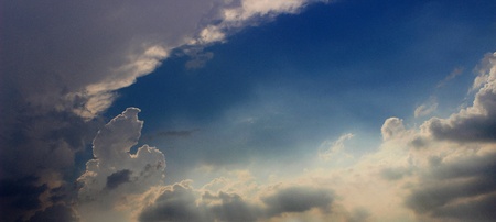 Blue sky coming out of white cloudsの写真素材