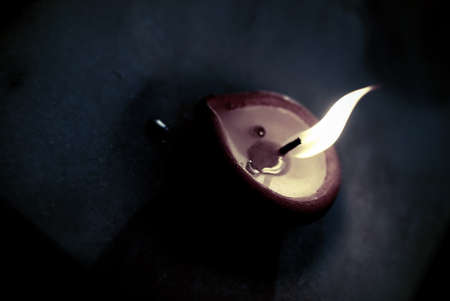 Single lighted wax lamp (diya)