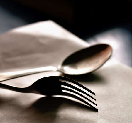 Spoon and fork kept on a white baseの写真素材