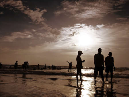 Silhouettes of people having fun on the beach