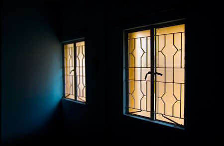Two windows in dark roomの写真素材