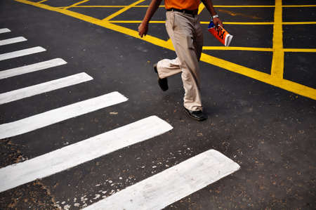 Urban man crossing the roadの写真素材