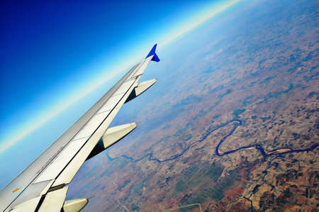 Wing of an Airplane shot through it's windowの写真素材
