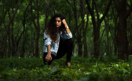 Adult young bold female model in the forest