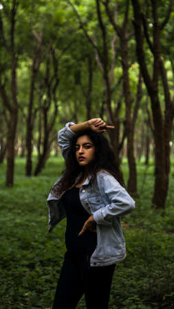 Adult young bold female model in the forest