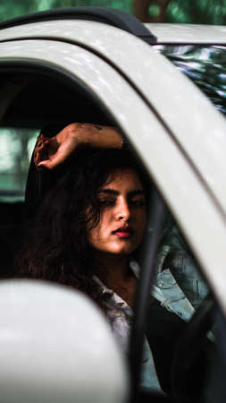 Adult young bold female model in car