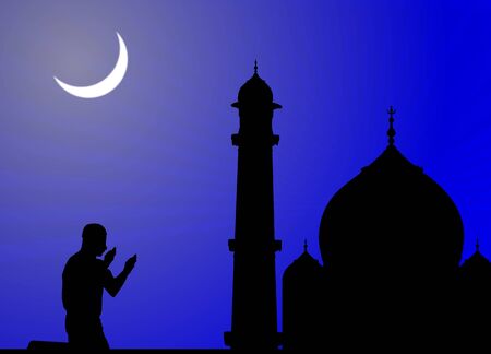 silhouette of human offering prayers at mosque の写真素材