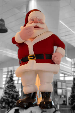 Big Santa Claus idol at mall with christmas tree in background for the christmas celebration.の写真素材