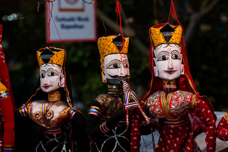 Colorful handmade Rajasthani puppets in display for sale to decorate in Home or shops in New Delhi,...