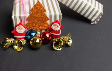 Christmas Decoration, Santa Claus with balls and gifts isolated on Black background. Concept photo for christmas greetings and celebrations.の写真素材