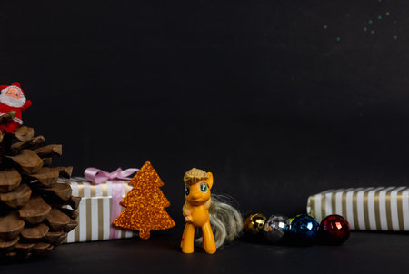 Christmas gifts and tree with toys on blackの写真素材