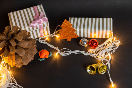 Christmas gifts and tree with toys on blackの写真素材