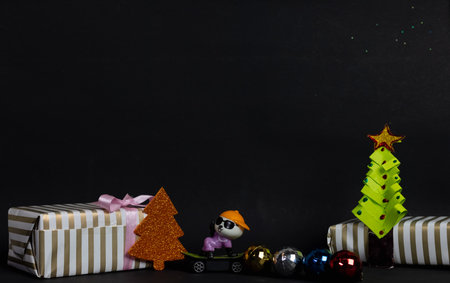 Christmas gifts and tree with toys on blackの写真素材