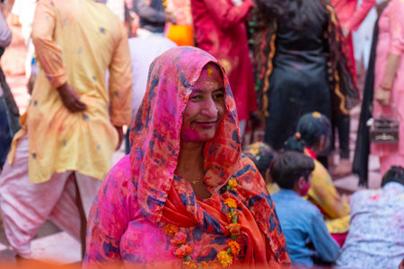 BARSANA, UTTAR PRADESH / INDIA - MARCH 2020: People celebrate the traditional and a ritualistic colorful Lathmar Holi with dance and colored faces at Radharani templeのeditorial素材