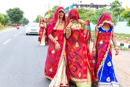 Khatu Shyam, Rajasthan / India - August 2019 : Beautiful Rajasthani women in traditional red sari...