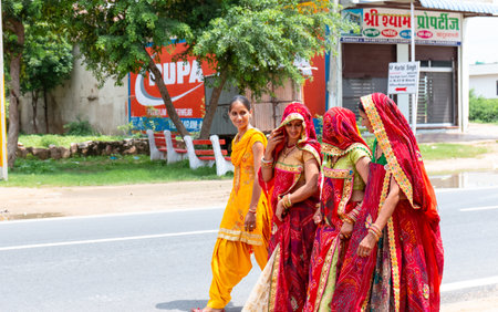 Khatu Shyam, Rajasthan / India - August 2019 : Beautiful Rajasthani women in traditional red sari...