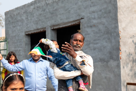 NOIDA, UTTAR PRADESH, INDIA - JANUARY 2020 : Young Indian students from Slum or Village area celebrating Indian Republic Day function at school with Indian National flag in hand.のeditorial素材