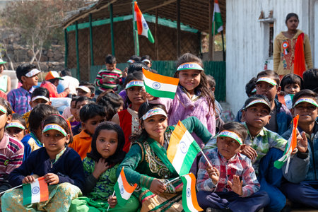 NOIDA, UTTAR PRADESH, INDIA - JANUARY 2020 : Young Indian students from Slum or Village area celebrating Indian Republic Day function at school with Indian National flag in hand.のeditorial素材