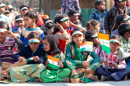 NOIDA, UTTAR PRADESH, INDIA - JANUARY 2020 : Young Indian students from Slum or Village area celebrating Indian Republic Day function at school with Indian National flag in hand.のeditorial素材