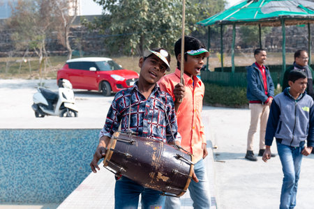 NOIDA, UTTAR PRADESH, INDIA - JANUARY 2020 : Young Indian students from Slum or Village area celebrating Indian Republic Day function at school with Indian National flag in hand.のeditorial素材