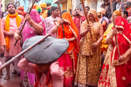 BARSANA, UTTAR PRADESH, INDIA - MARCH 2020 : Unidentified people from Nandgaon visits Barsana to play colorful Holi with the Women of Barsana as ritual of Lathmar holi every year.のeditorial素材