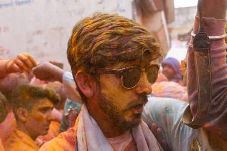 BARSANA, UTTAR PRADESH, INDIA - MARCH 2020 : Unidentified people from Nandgaon visits Barsana to play colorful Holi with the Women of Barsana as ritual of Lathmar holi every year.のeditorial素材