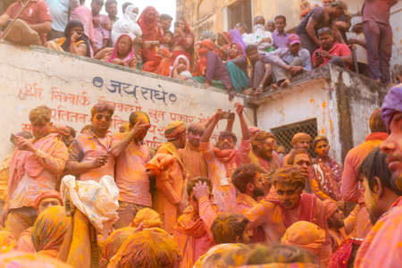 BARSANA, UTTAR PRADESH, INDIA - MARCH 2020 : Unidentified people from Nandgaon visits Barsana to play colorful Holi with the Women of Barsana as ritual of Lathmar holi every year.のeditorial素材