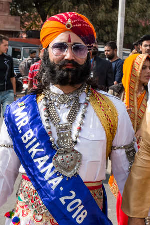 Bikaner, Rajasthan, India - January 2019 : Portrait of Rajput male  from bikaner city with big mustache, beard and colorful turban in traditional attire and necklace participating in camel festival.のeditorial素材