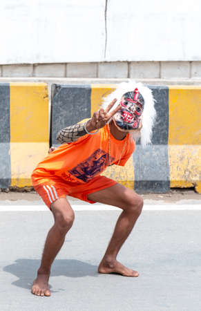 GHAZIABAD, UTTAR PRADESH, INDIA - JULY 2019: A hindu devotee carrying kanwar on their shoulder to...