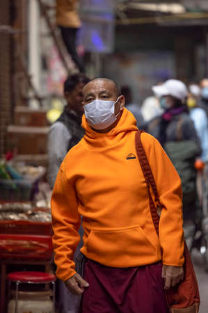 New Delhi, India - December 2021: Portrait of Indian tibetan monk lama in red color clothing  at tibetan monastery area.のeditorial素材