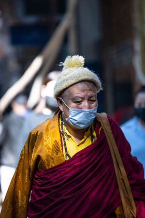 New Delhi, India - December 2021: Portrait of Indian tibetan monk lama in red color clothing  at tibetan monastery area.のeditorial素材