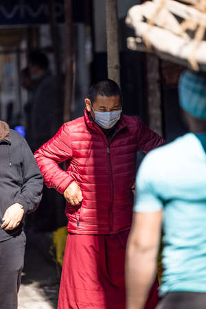 New Delhi, India - December 2021: Portrait of Indian tibetan monk lama in red color clothing  at tibetan monastery area.のeditorial素材