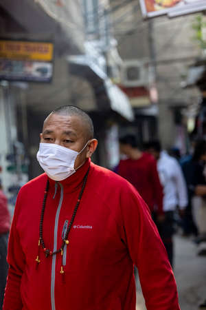 New Delhi, India - December 2021: Portrait of Indian tibetan monk lama in red color clothing  at tibetan monastery area.のeditorial素材