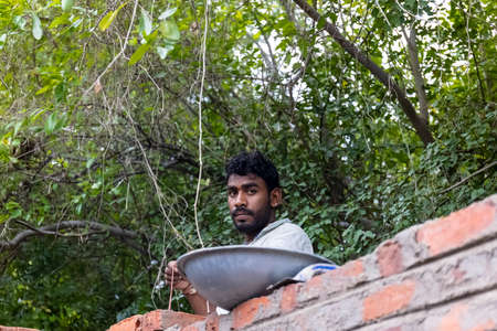 Jawai, Rajasthan, India - September 2021: Indian Labour, Portrait of male labor working at newly...