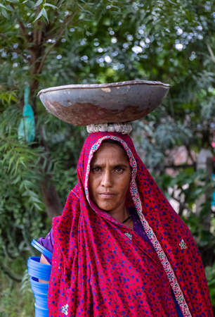 Jawai, Rajasthan, India - September 2021: Portrait of Indian woman working at construction site in...
